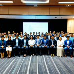 **

A diverse group of professionals in modest business attire attending a blockchain technology conference in Kuala Lumpur. The background shows presentation slides with blockchain diagrams and Malaysian flags. The scene conveys innovation and collaboration. Fully clothed, appropriate content, safe for work, perfect anatomy, natural proportions, professional photography, high quality, professional.

**